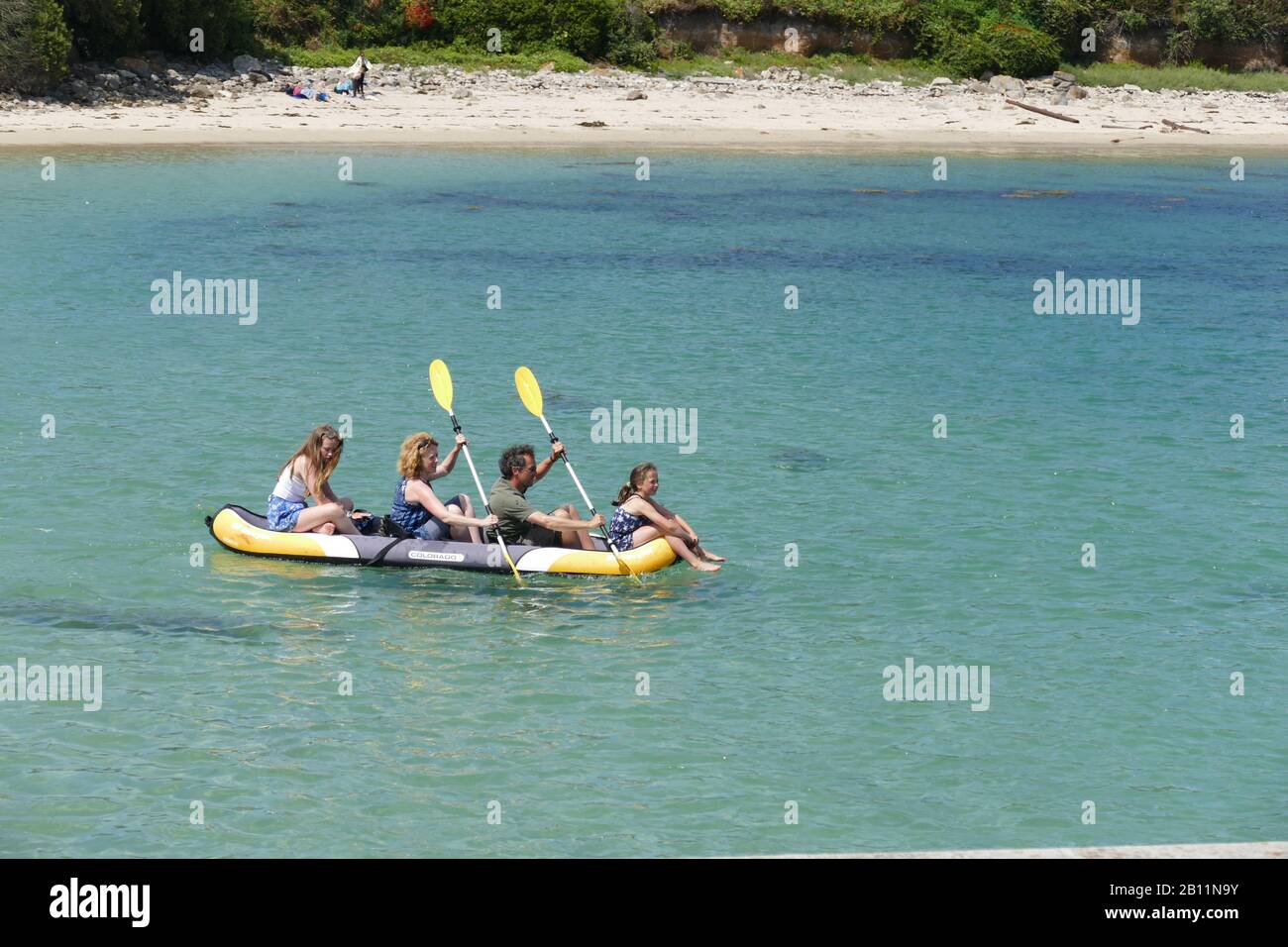 A family and their inflatable kayak  at Bryher,  Isles of Scilly, Cornwall, U.K. Stock Photo