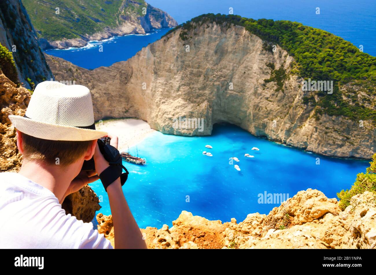 Tourist taking photo of famous resort in Greece, Navagio beach. Summer vacation on Zakynthos island. Stock Photo