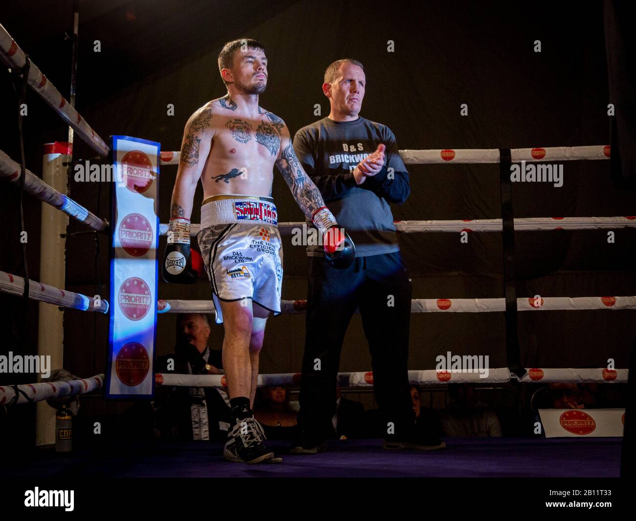 TAUNTON, UNITED KINGDOM. 21 Feb 2020. Yeovil boxer Dean Dodge (black trunks) fought Birmingham boxer and former English Champion & WBC International Super Bantamweight Champion Sean Davis (white trunks) at the Wellsprings Leisure Centre in Taunton, hosted by Priority Boxing Promotions. He fought hard to get a knock-out from the start but due to damaging his right hand in the second round he was hindered but won on points after 6 three-minute rounds. This makes Dodge, nicknamed El Diablo, undefeated in 10 professional fights and confident of a title shot in the near future. Stock Photo