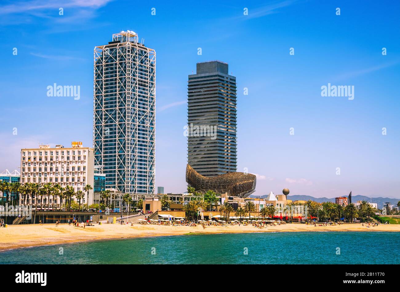 Scenic view on Barcelona beach and skyscrapers at summer day Stock Photo