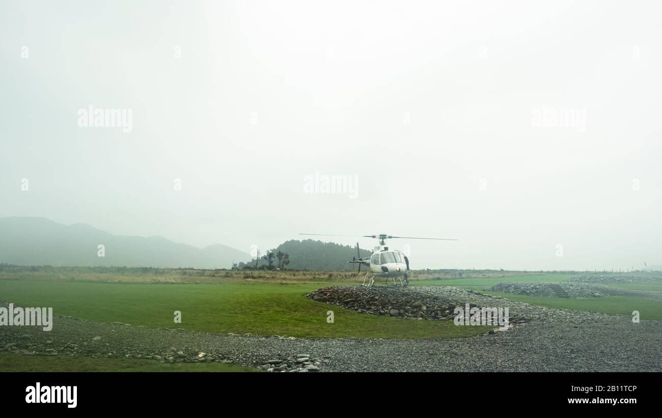 Helicopter in the fog, Franz Josef, New Zealand Stock Photo