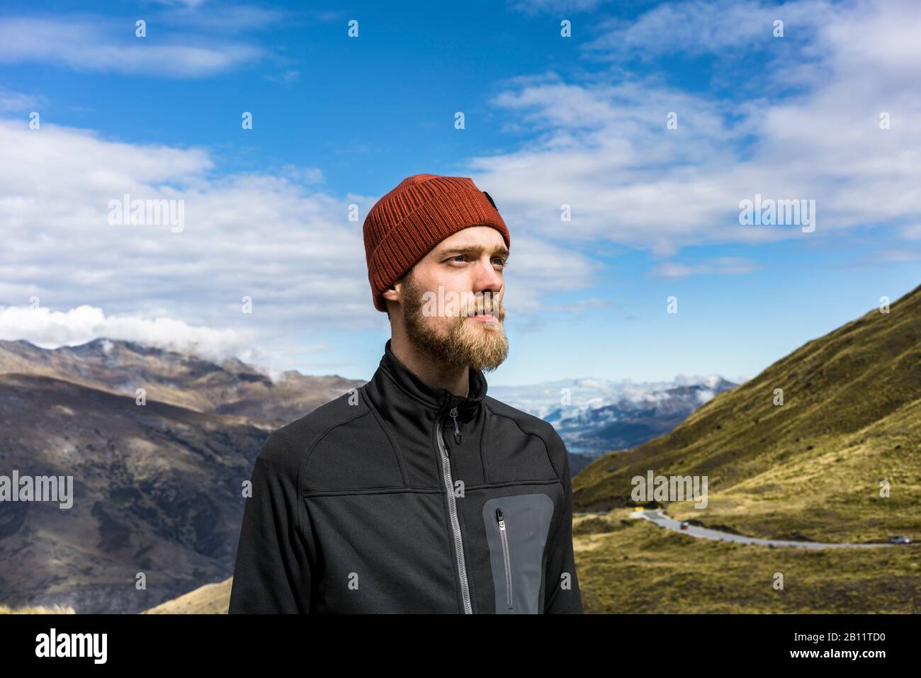 Portrait of a young man on Crown Range Road, New Zealand Stock Photo