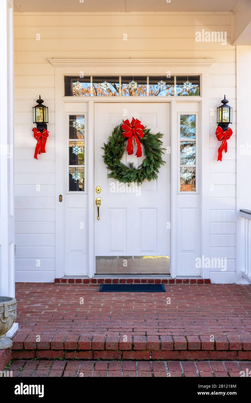 Residential home front door decorated for Christmas Stock Photo
