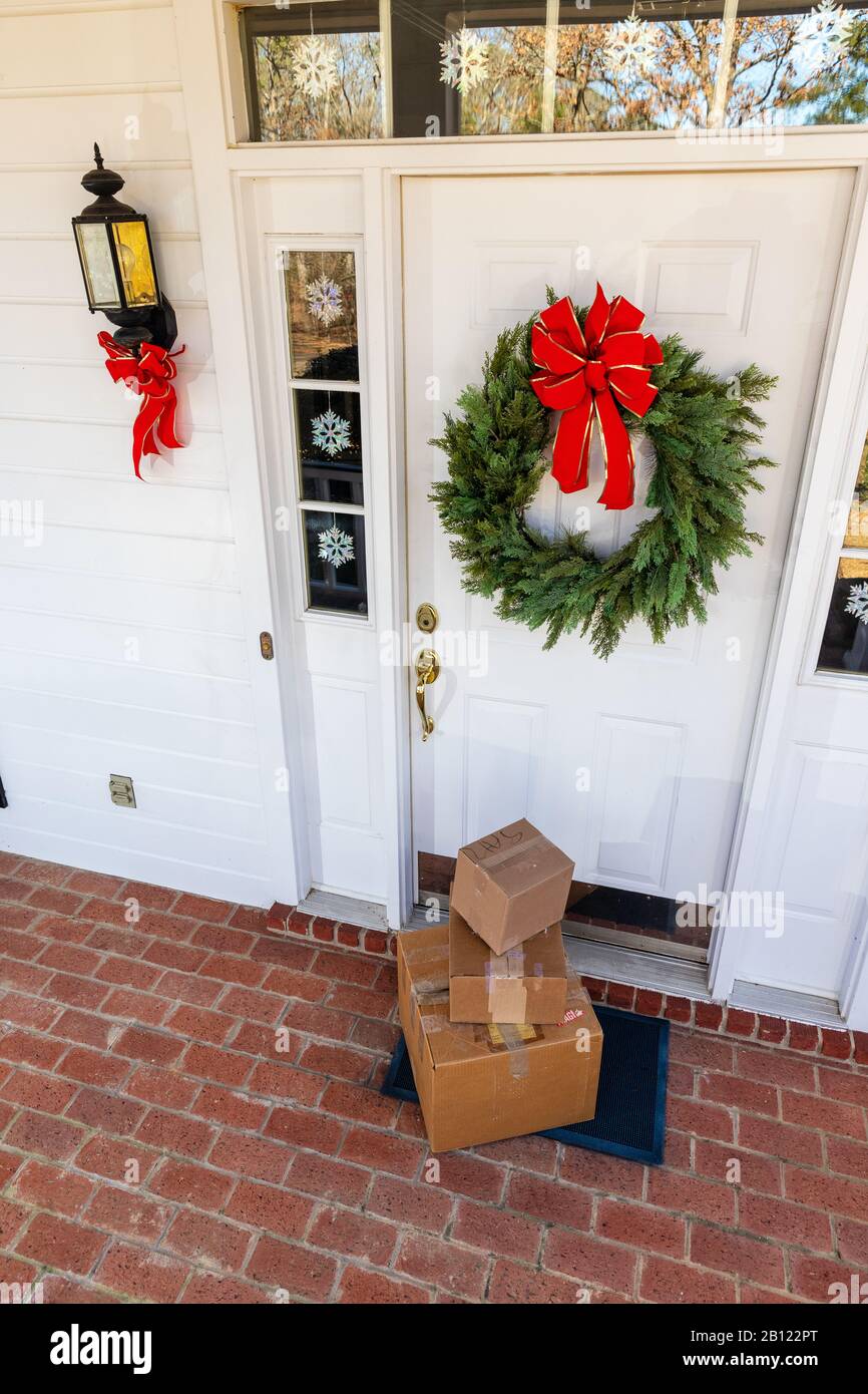 Packages on front porch of home during holiday season Stock Photo