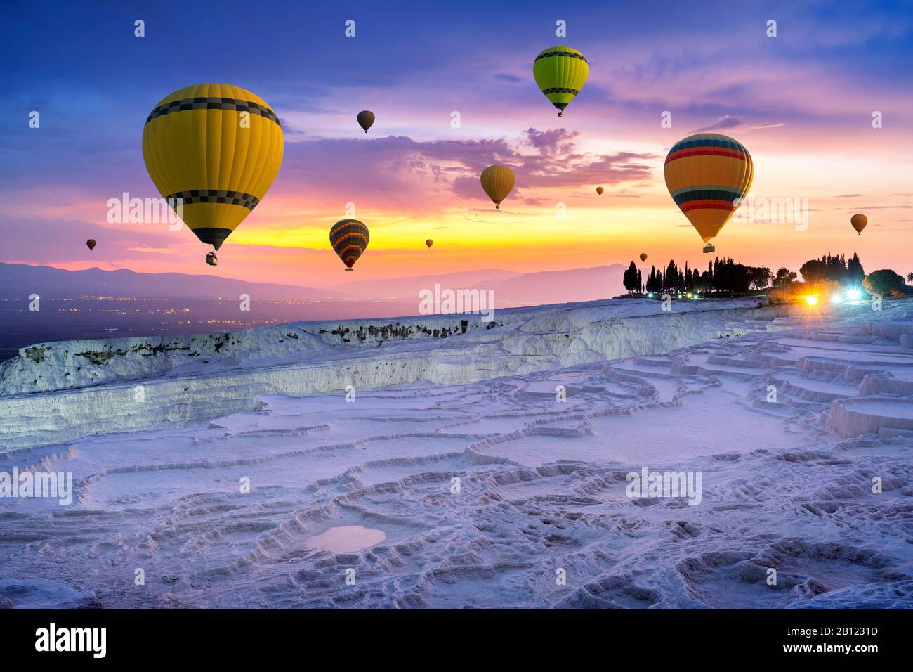 Hot air balloons and Natural travertine pools at sunset in Pamukkale,  Turkey Stock Photo - Alamy