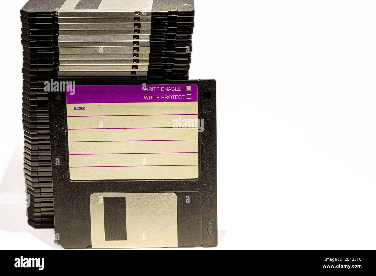 numerous black floppydisks lined up on a white background Stock Photo