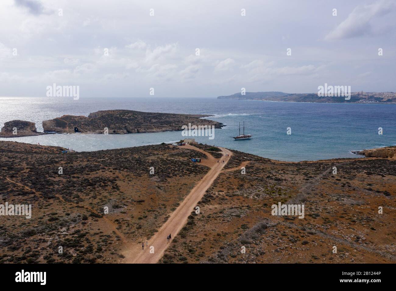 Aerial drone view Comino, Malta Blue Lagoon to enjoy the clear turquoise water with clear blue sky and boats in summer Stock Photo