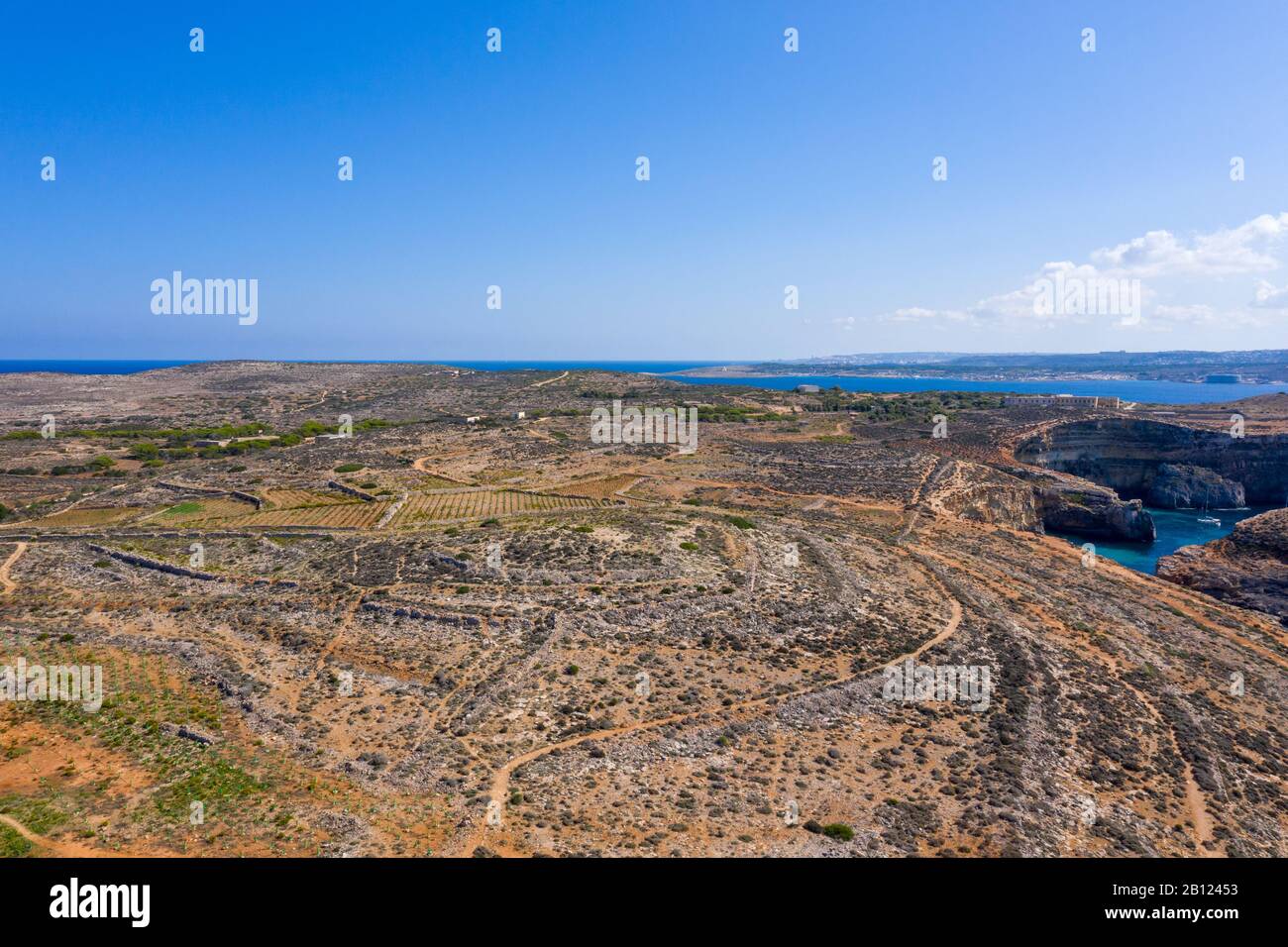 Aerial drone view Comino, Malta Blue Lagoon to enjoy the clear turquoise water with clear blue sky and boats in summer Stock Photo