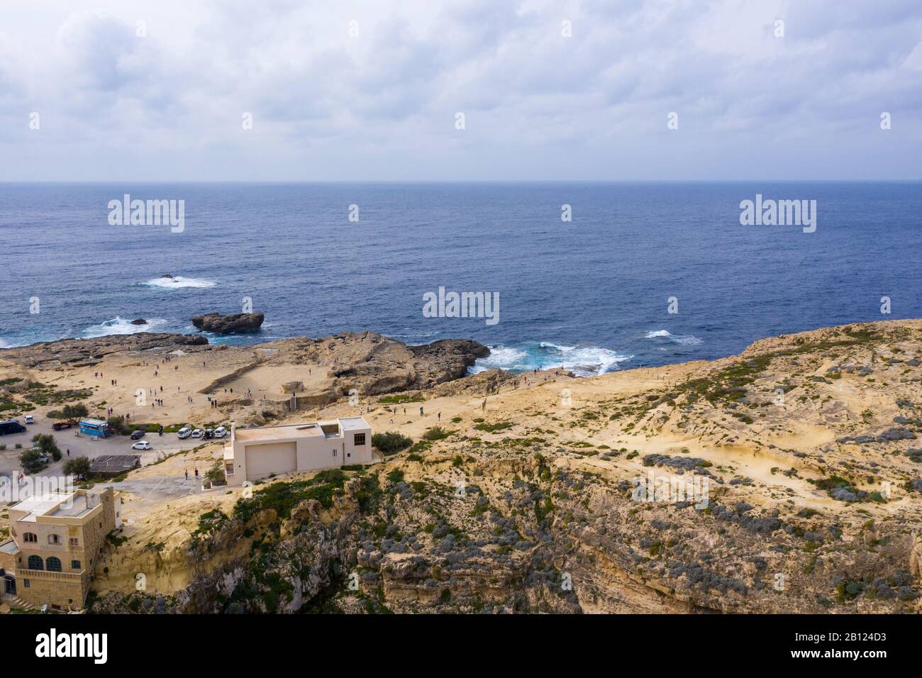 Aerial drone view of rocky coastline and sea. Blue hole and the collapsed Azure window in Dwejra Bay, Gozo, Malta Stock Photo
