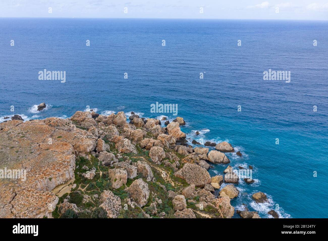 Ghajn Tuffieha, Malta - Aerial panoramic view of the coast of Ghajn Tuffieha with Gnejna Bay, Riviera Bay and Golden Bay at sunrise in summer Stock Photo