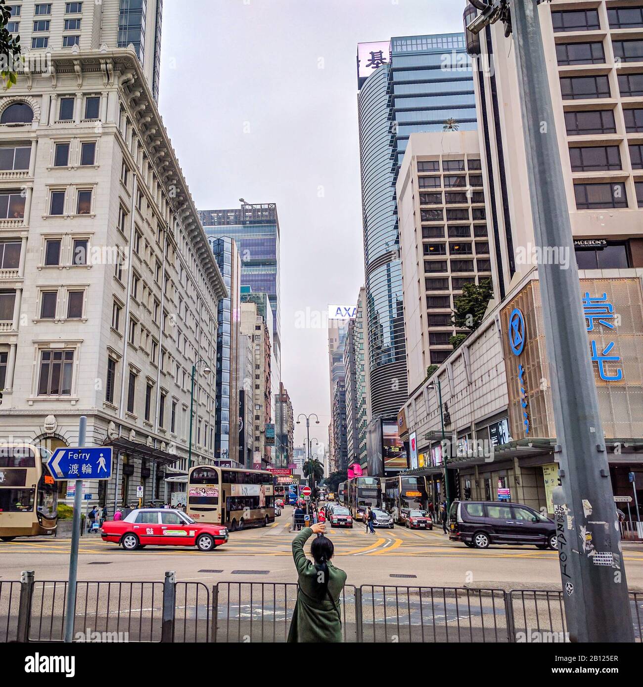 Hong Kong, Hong Kong Special Administrative Region of the People's Republic of China - February 19, 2017 : A woman photographs the street in Hong Kong Stock Photo