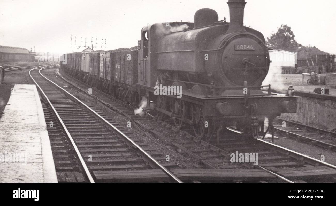 Vintage black and white photo of steam locomotive train - J.52 0-6-0 ST 68846 on a down coal train at Wood Green Station August 1956. Stock Photo