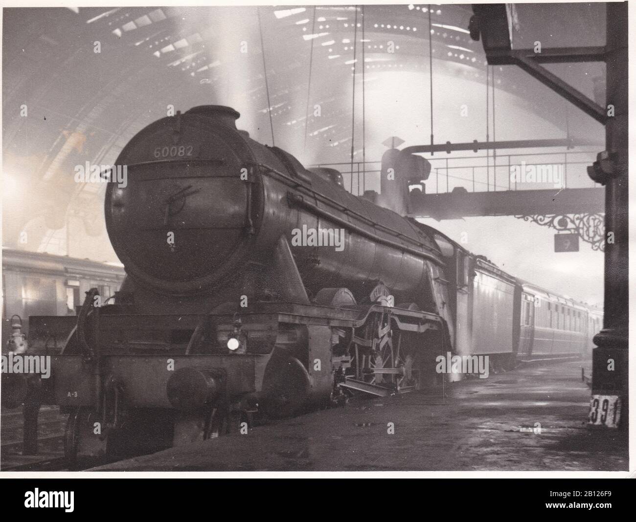 Vintage black and white photo of steam locomotive train - Greasley A.3 60082 Neil Gow in York Station on the Kings Cross to Newcastle December 1956. Stock Photo