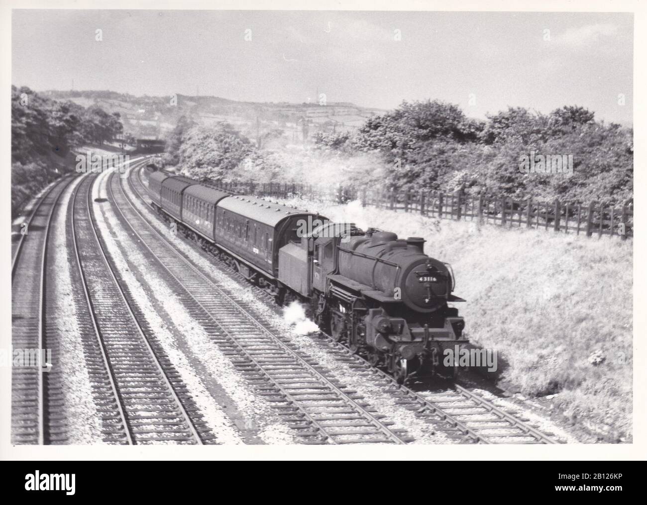 Vintage black and white photo of steam locomotive train - Ivatt Class 4MT 2-6-0 on a Manchester Vic to Normanton train near Thornhill May 1957. Stock Photo