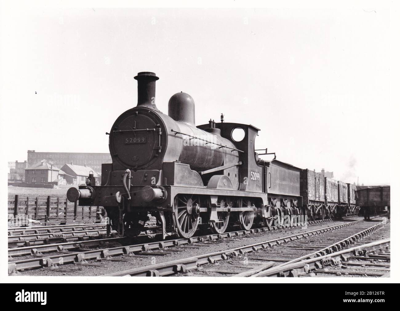 Vintage black and white photo of steam locomotive train - L.M. Ex LPY Class 3F 0-6-0 52099 on the Diggle -Oldham Glodwick Road freight at Lees Sidings. Stock Photo
