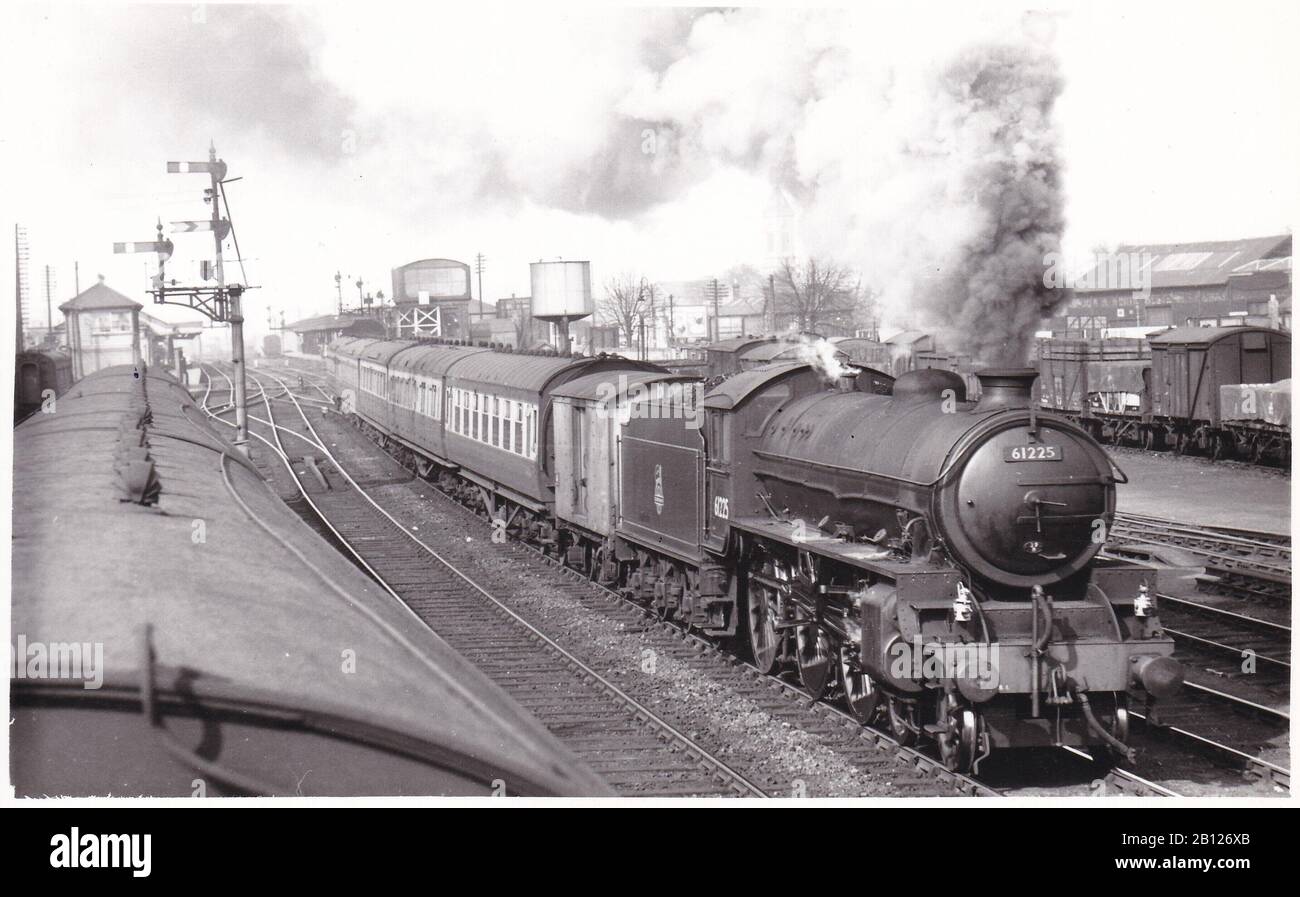 Vintage black and white photo of steam locomotive train - 61225 Class B1 4-6-0 leaving Oxford Station, train is composed of L.M & G.W. Stock 1950s. Stock Photo