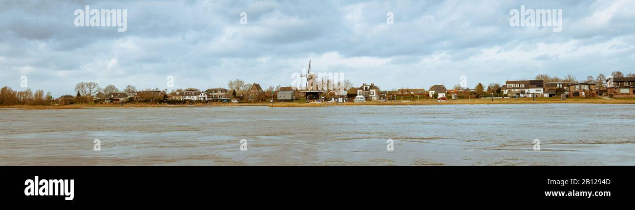 Panoramic photo of the IJssel rain river with the picturesque village of Veessen on the other side Stock Photo