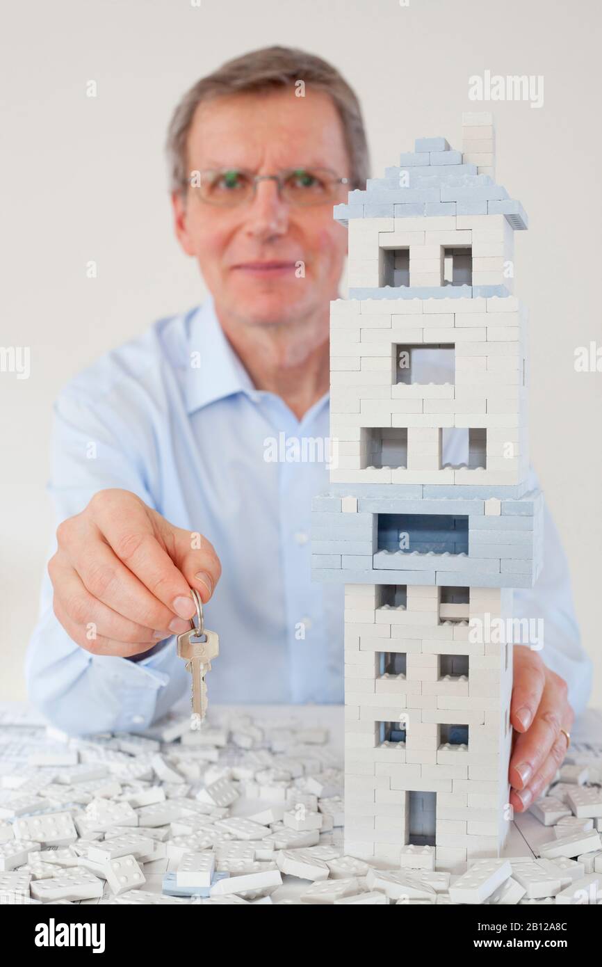 Smiling architect presenting the keys for a house Stock Photo