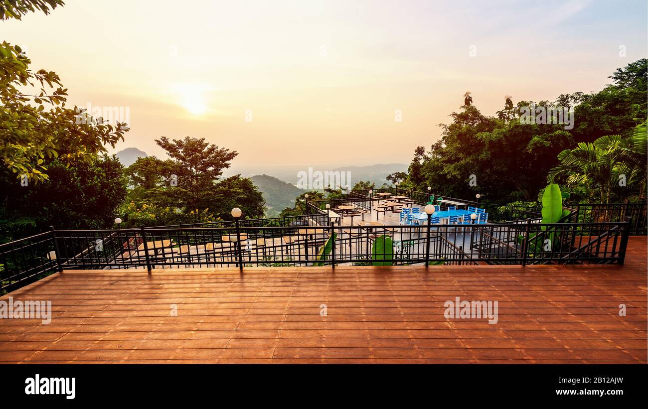 High angle viewpoint for watching the beautiful nature landscape colorful sky during the sunset. Table and chairs on the terrace for dining of the res Stock Photo