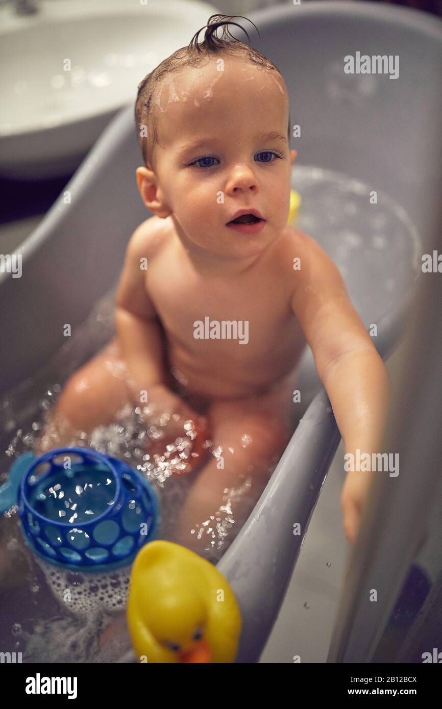 Cute boy play in the bathroom during washing and bathing Stock Photo