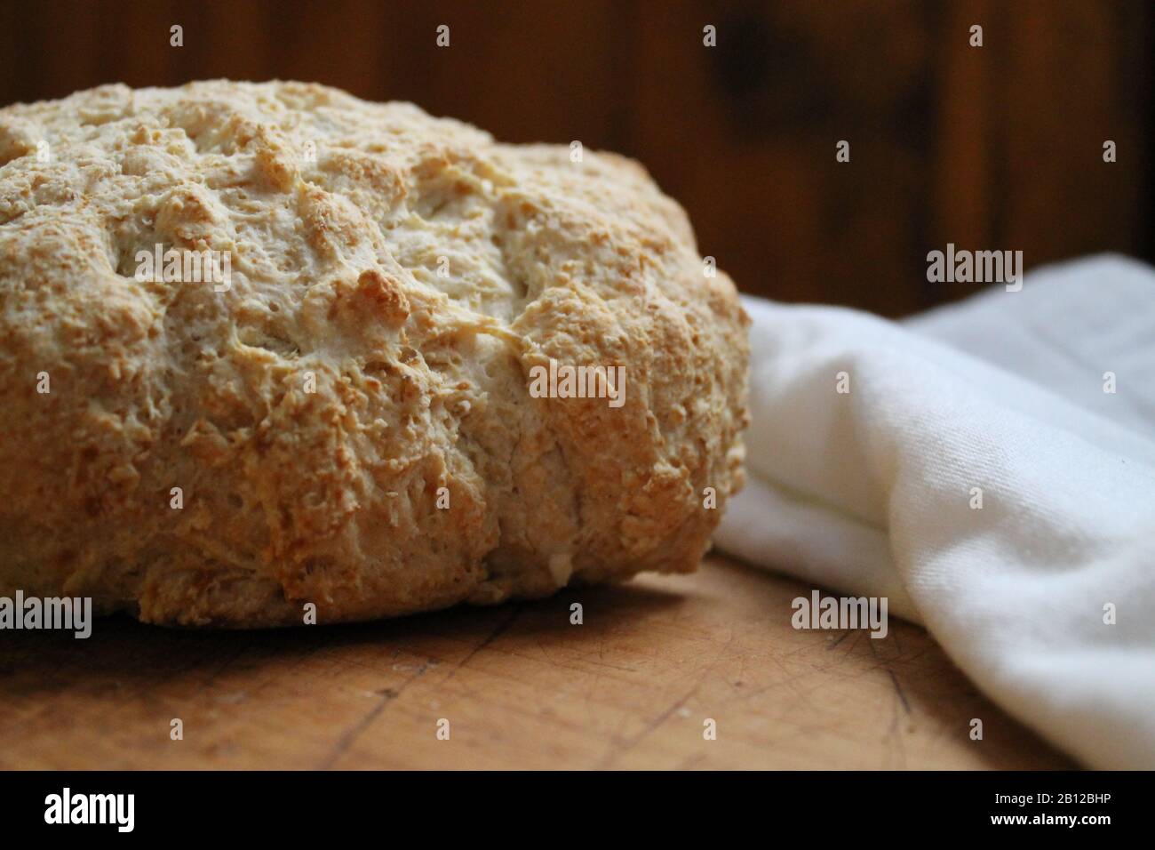 Fresh baked bread on wooden countertop Stock Photo