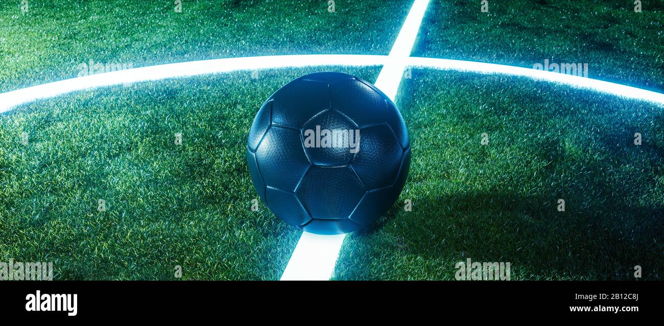 Neon soccer field with ball on glowing lines on a green grassy sports field at night in a panorama banner with copy space for sports or football theme Stock Photo