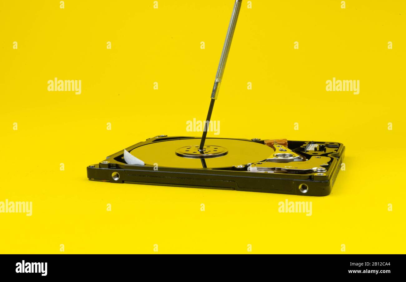 hard disk repair on a yellow background d Stock Photo - Alamy