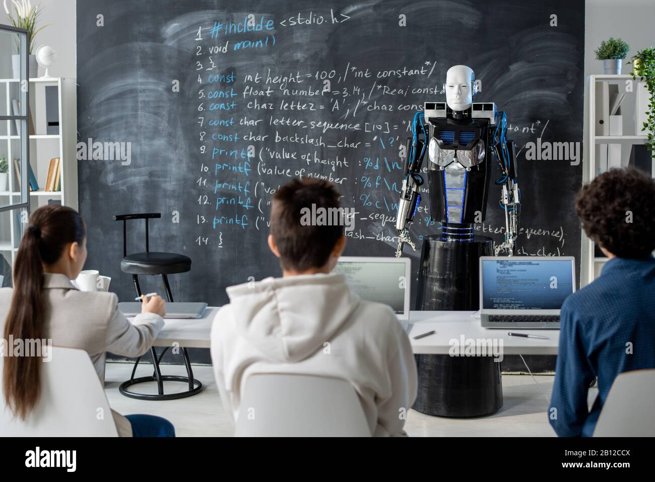 New generation robot presenting technical data to group of students Stock Photo