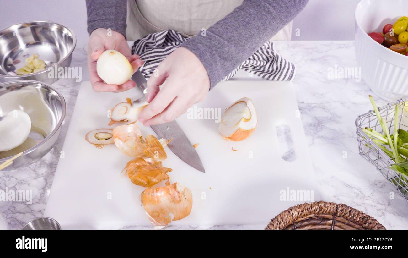 Step by step. Cutting vegetables on a white cutting board to make a one