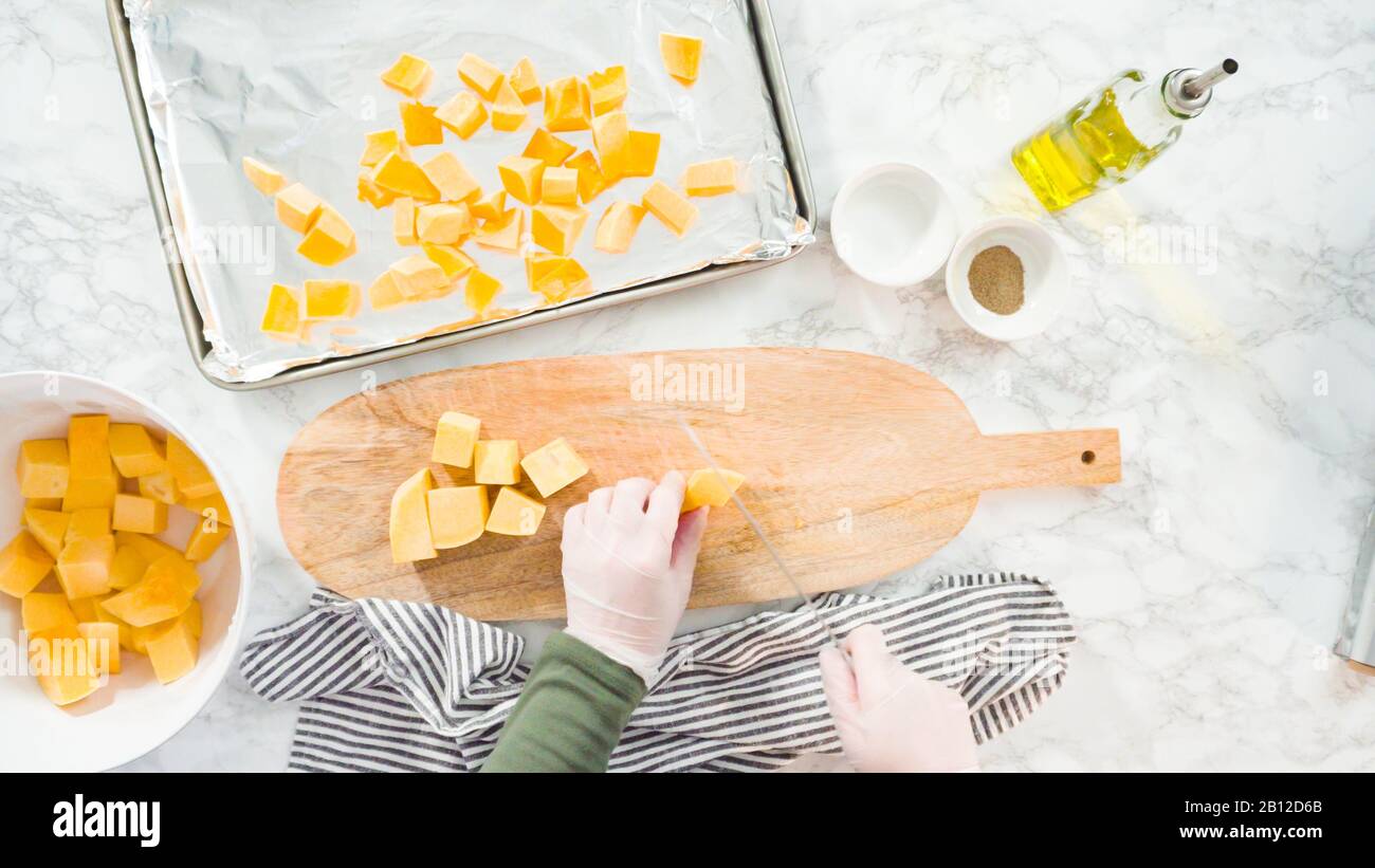 Cutting butternut squash on a wood cutting board Stock Photo Alamy