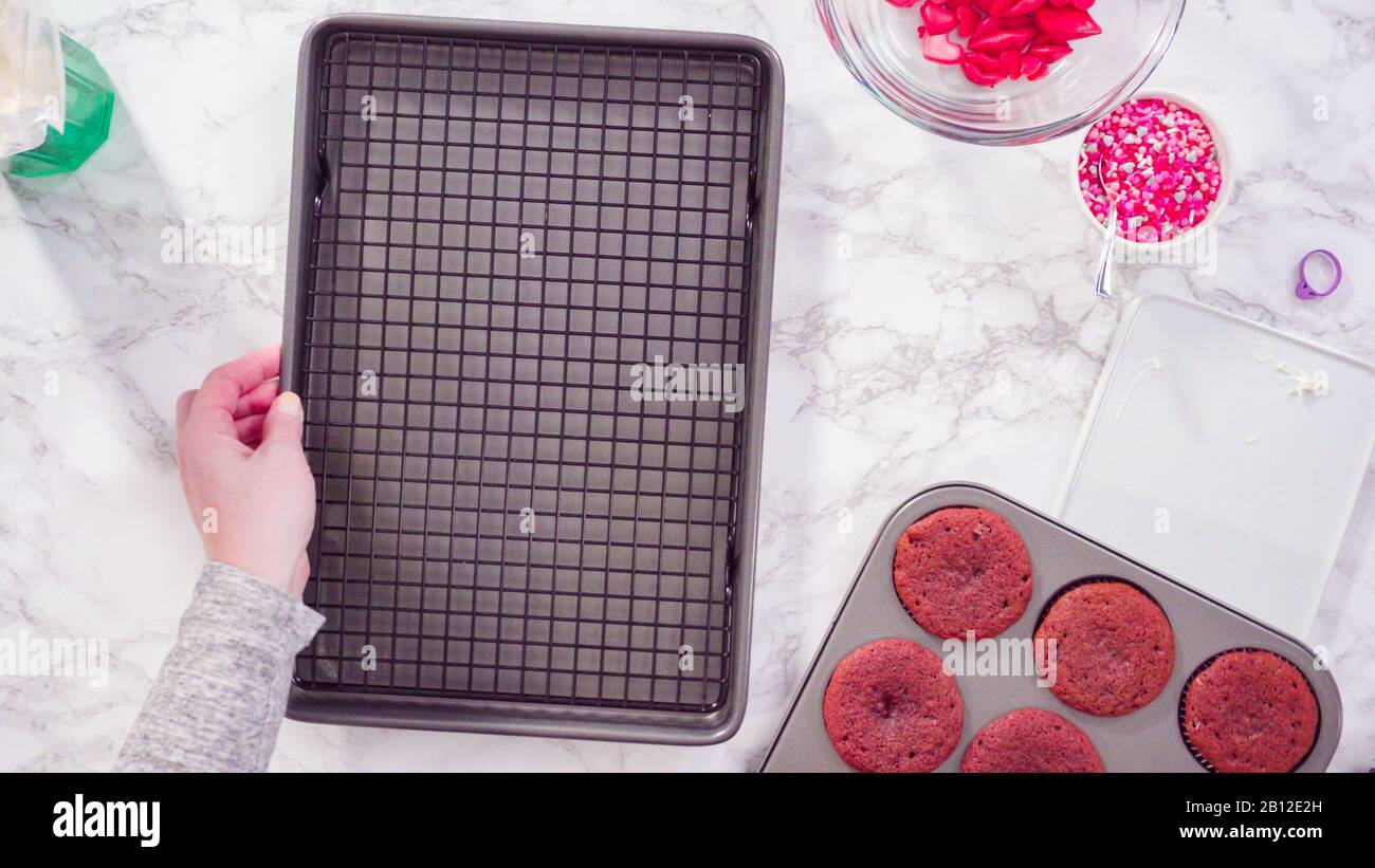 Flat lay. Step by step. Cooling red velvet cupcakes on a kitchen drying rack. Stock Photo