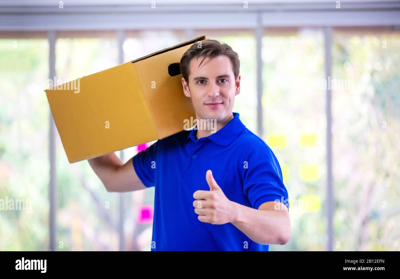 Portrait Of Courier With Delivering Package Stock Photo