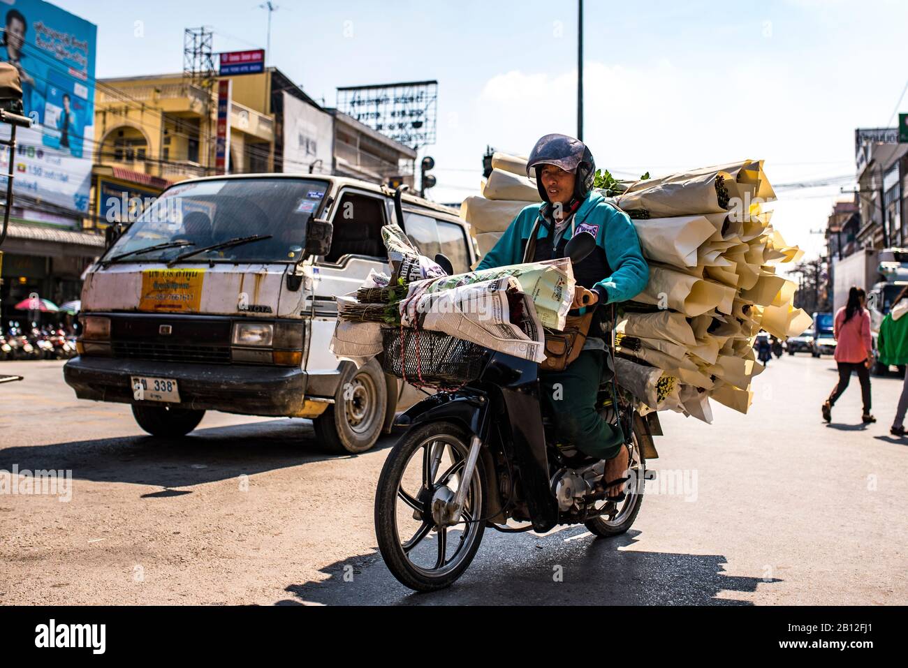 Motorcyclist transports flowers, border to Myanmar, Laos Stock Photo