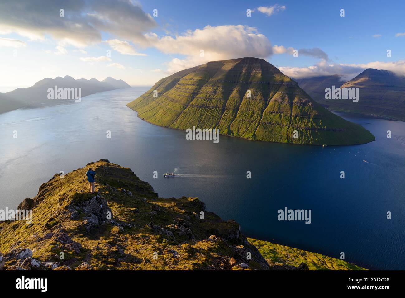 View of the fjord with passing ship near Klaksvik, Bordoy, Faroe Islands, Denmark Stock Photo
