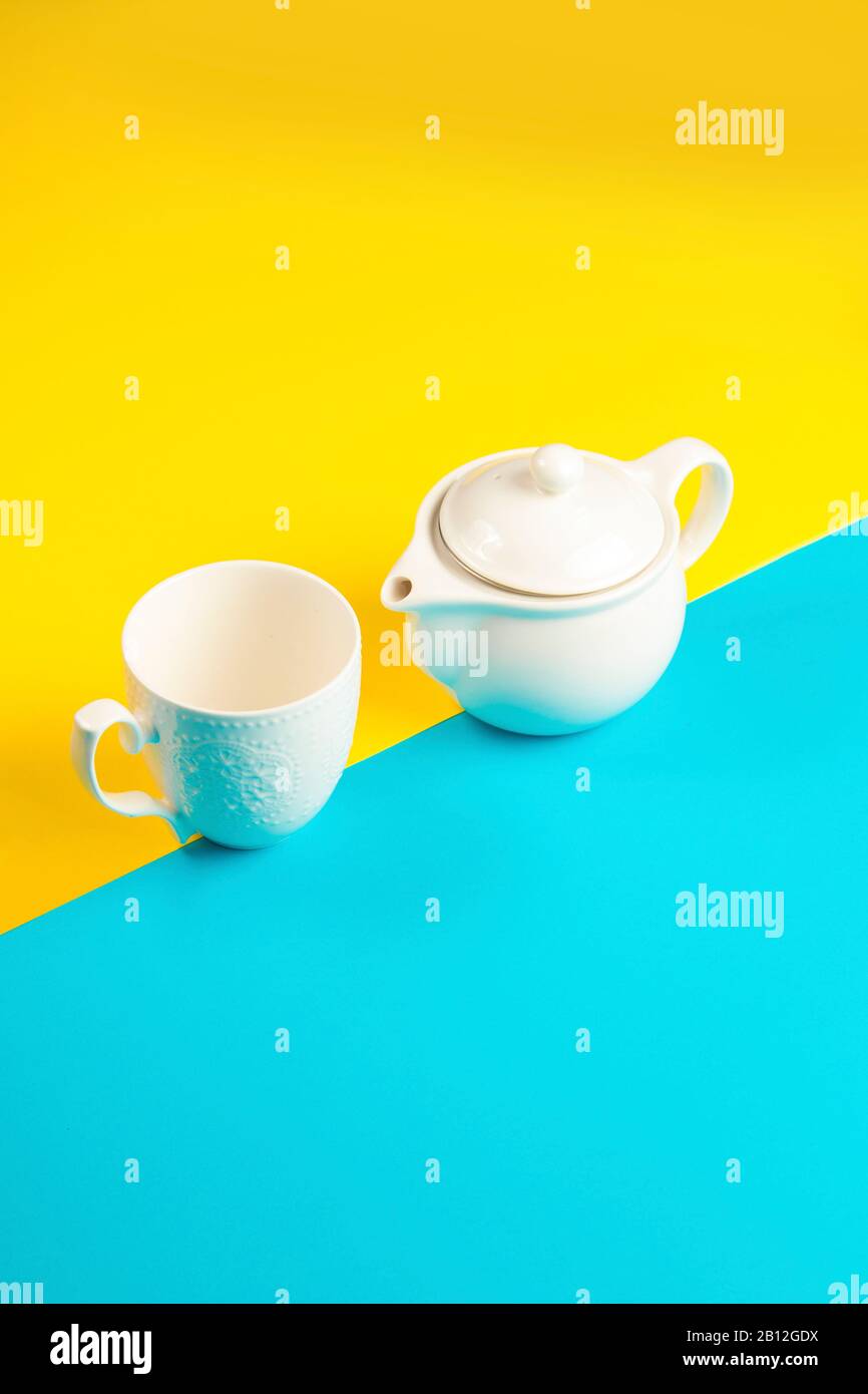 Tea pot and tea mug on a yellow and blue background Stock Photo Alamy