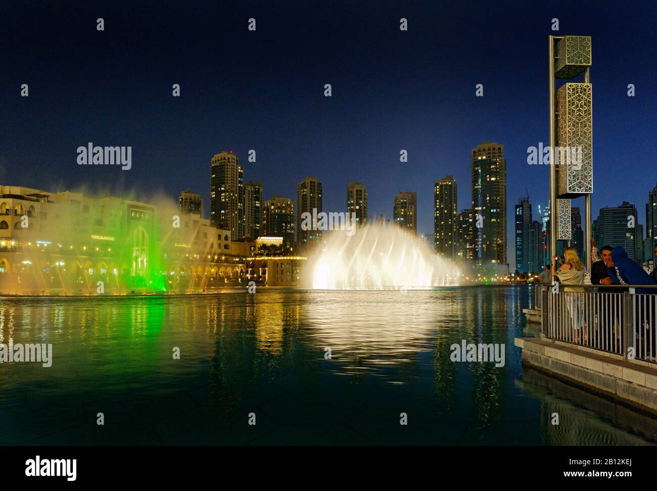 Dubai Fountains,the world's biggest light and water show,on the left
