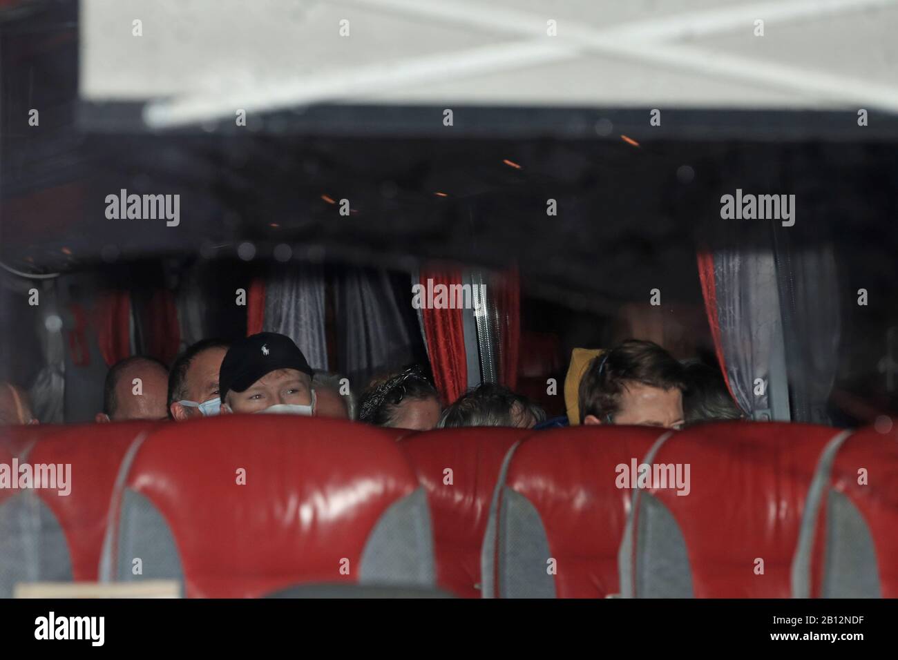 Passengers of an aircraft that repatriated British people to the UK from a cruise ship hit by the coronavirus in Yokohama, Japan, arrive by coach at Arrowe Park Hospital on Merseyside. Stock Photo