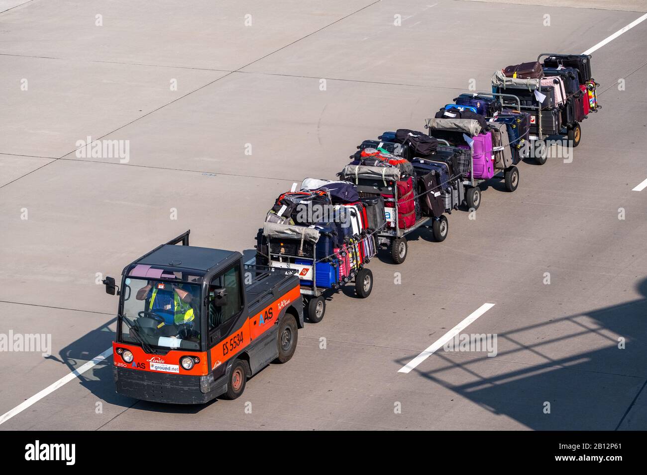 Loader carries passengers luggage at the airport Stock Photo - Alamy
