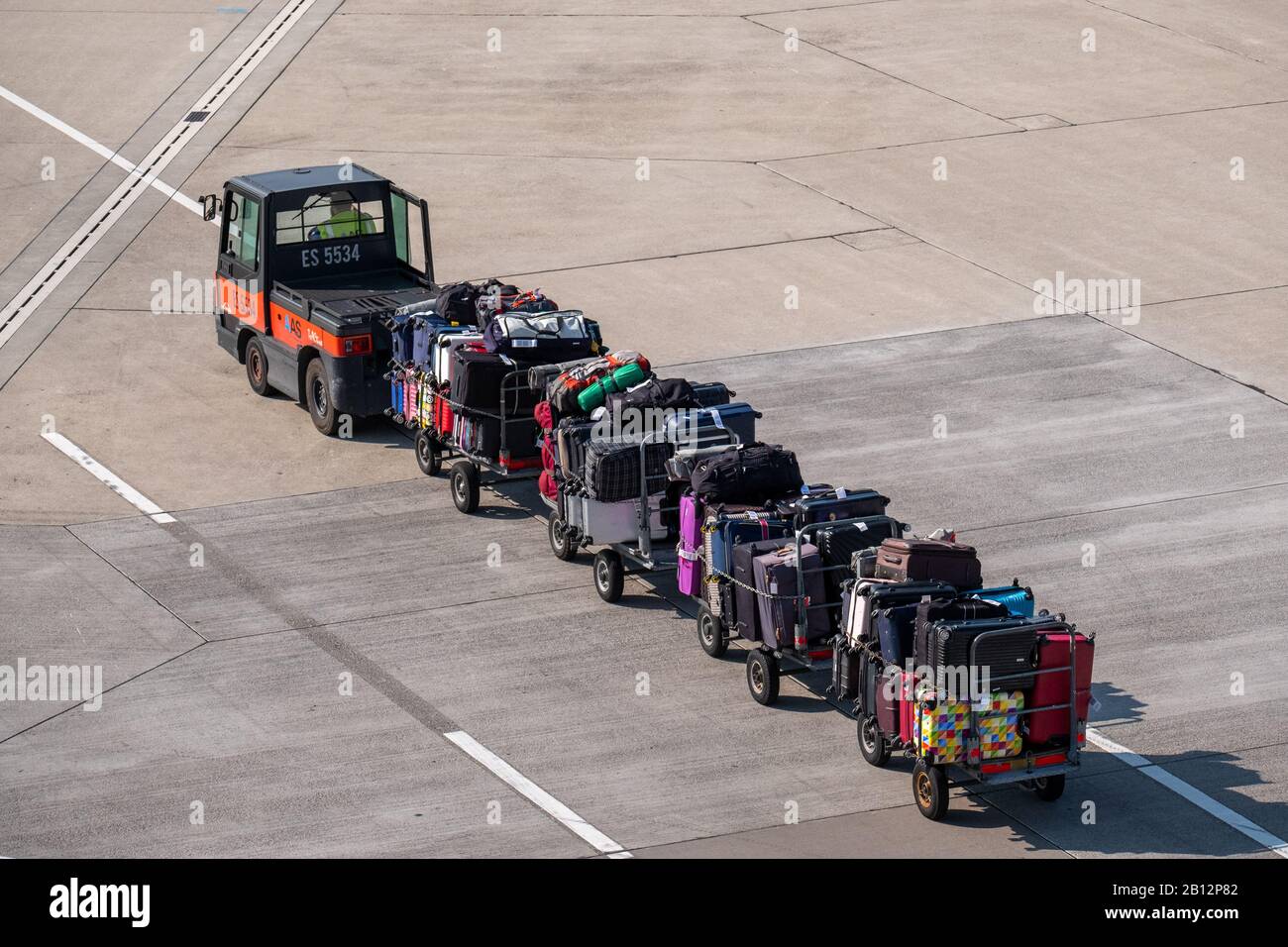 Loader carries passengers luggage at the airport Stock Photo - Alamy