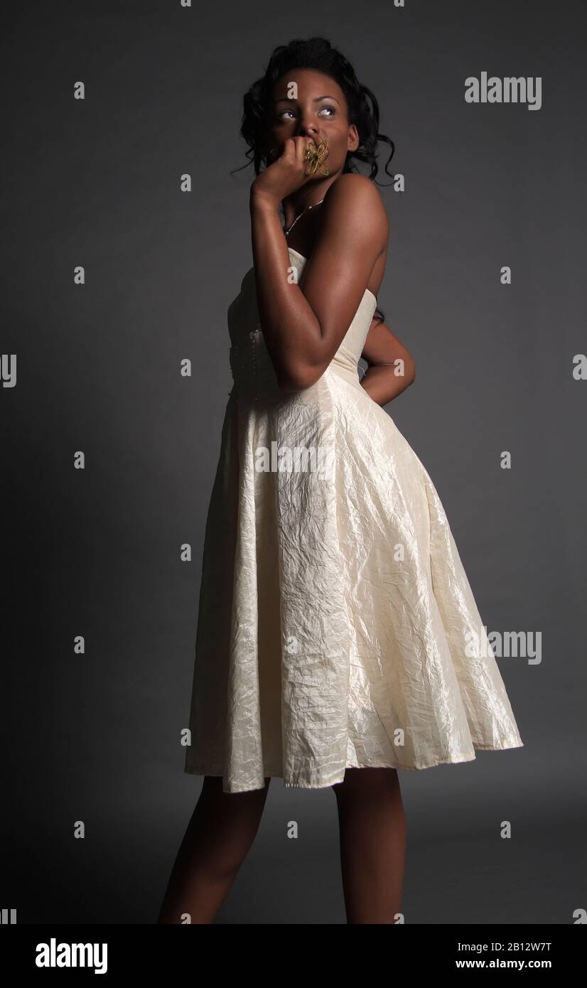 Young dark skinned woman wearing an ivory colored dress hi-res stock  photography and images - Alamy