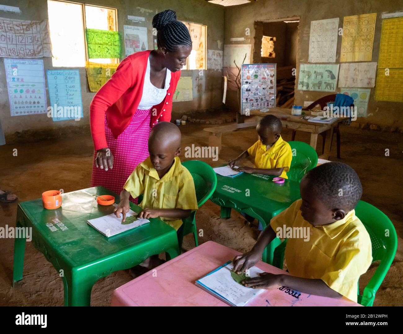 Teacher with young children at a small remote school high in the Sagalla Hills near Voi in Southern Kenya Stock Photo