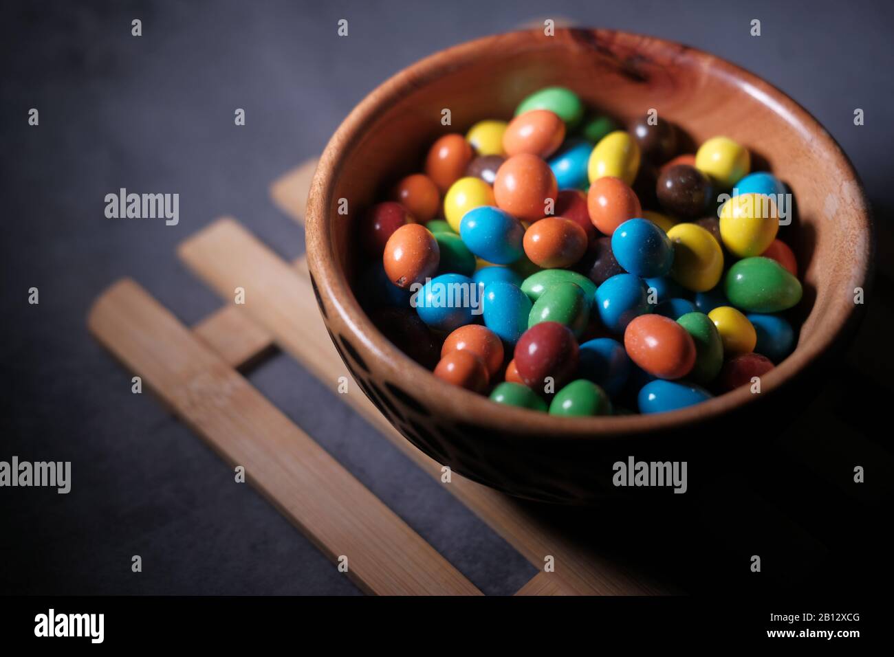 top view of colorful chocolate in a bowl on table  Stock Photo