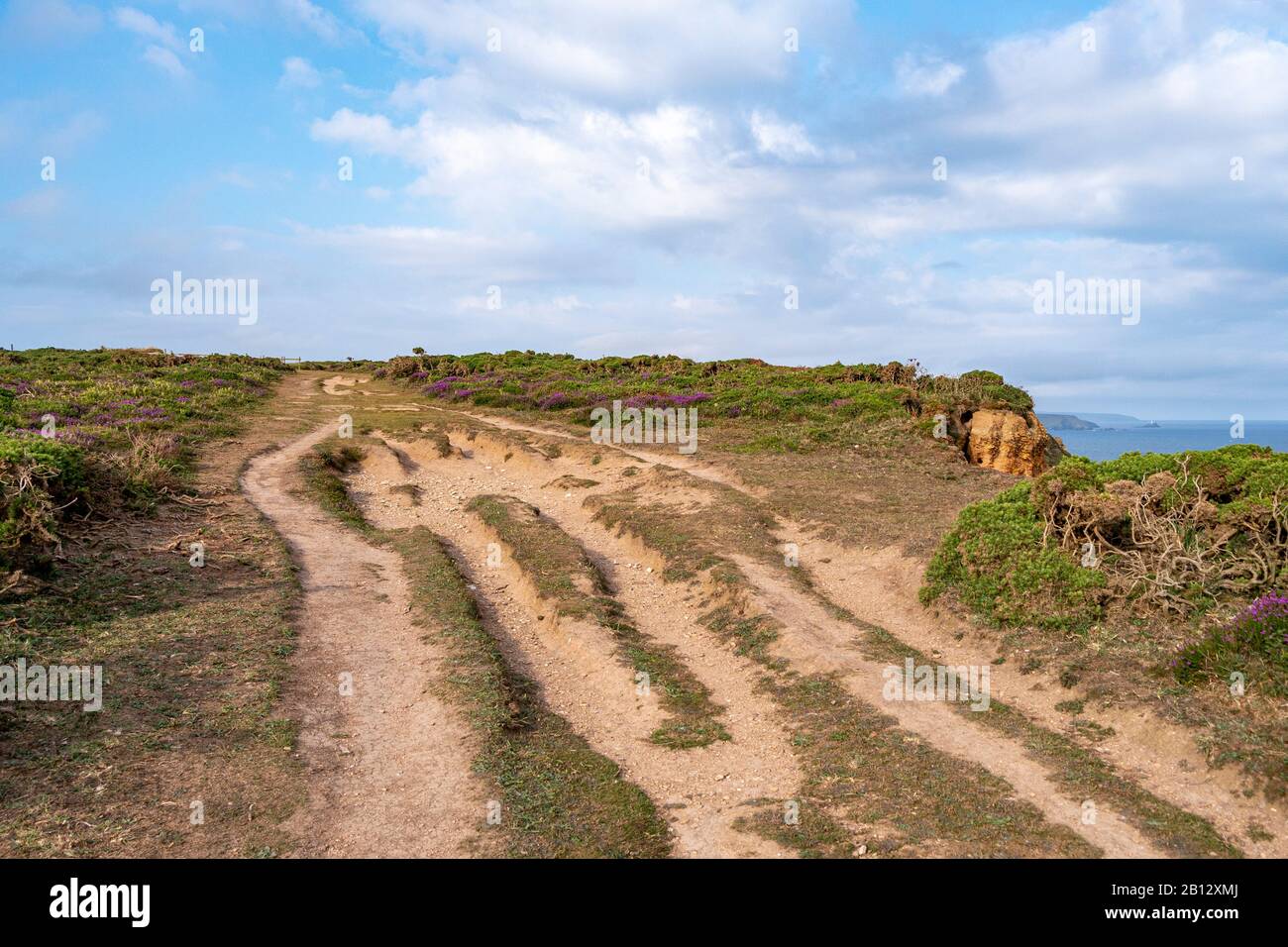 A rutted, well used South West Coast Path leading from Western Hill, south of Portreath, over the Caravannel Downs - Portreath, north Cornwall, UK. Stock Photo