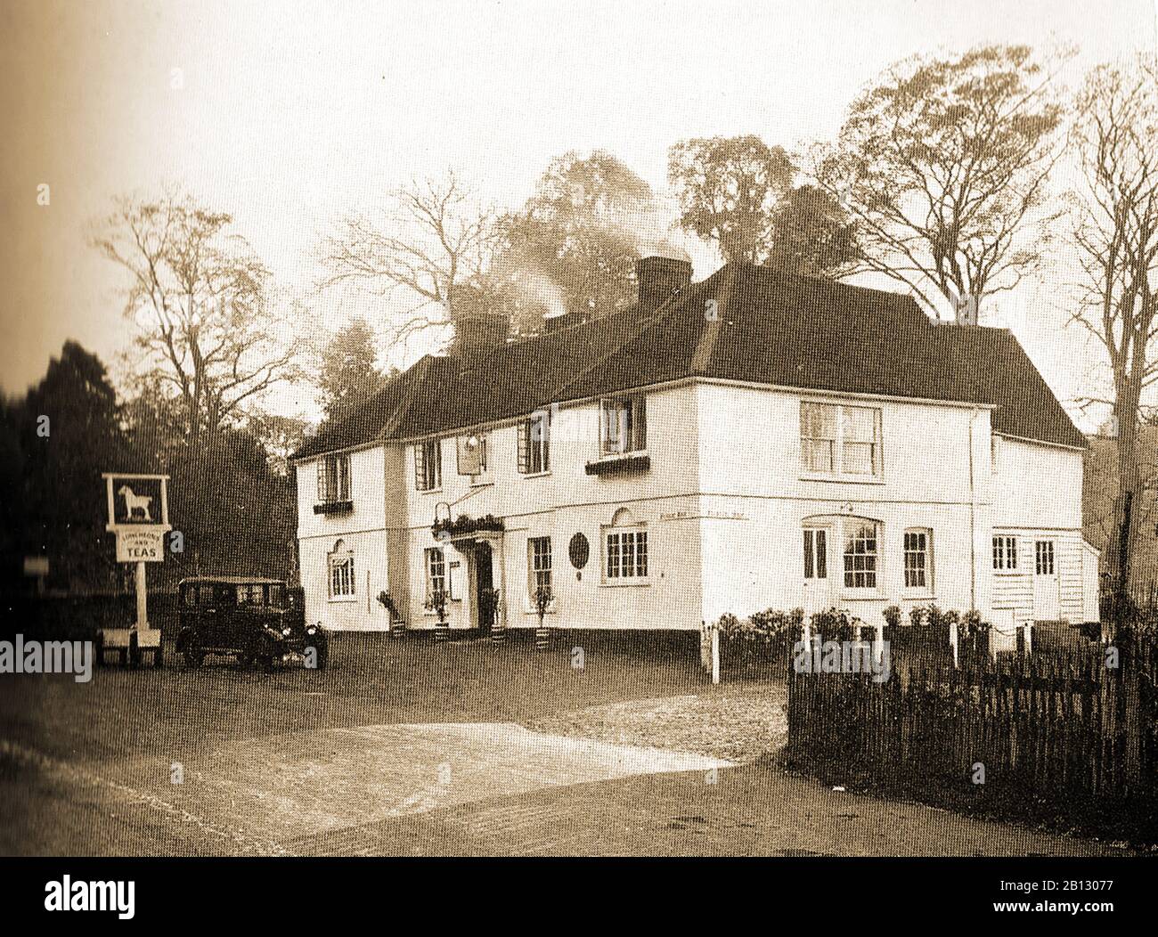 c 1940's-  An old photograph of the White Horse at Hertingfordbury, Hertfordshire, England. Though  The 15th century Grade II listed hostelry   closed in 2016, the pub is again up and running after refurbishment. A sign (on wheels) stands outside advertising teas. Stock Photo