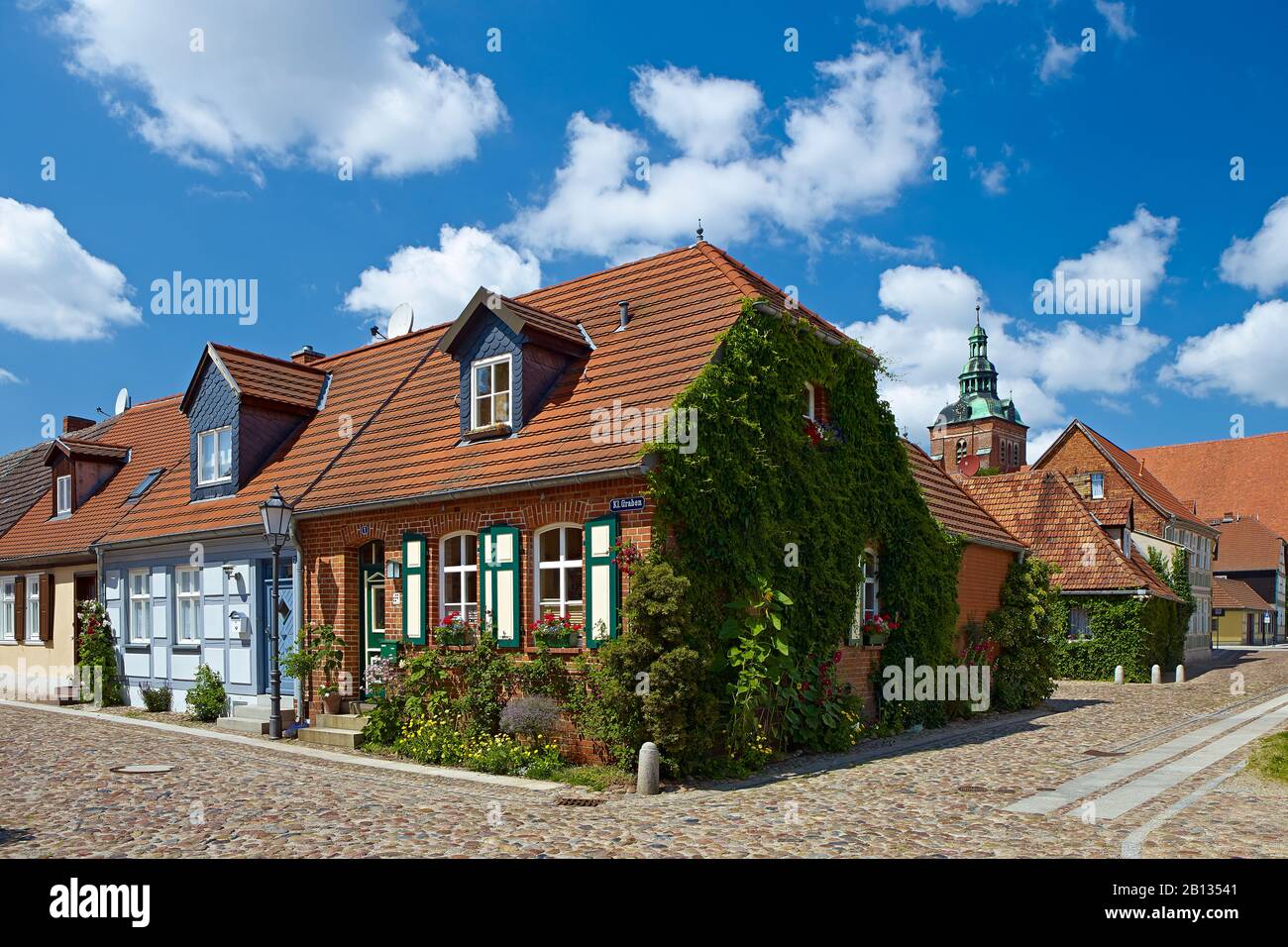 Houses at Kleiner Graben street and St. Mary's church tower in Wittstock,Brandenburg,Germany Stock Photo