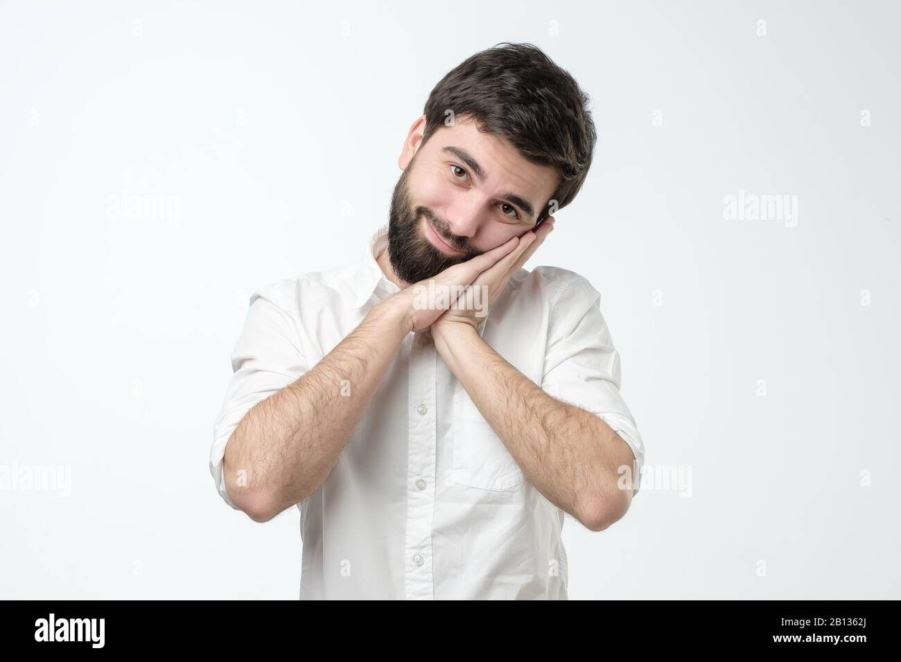 Hispanic man wearing white shirt sleeping tired dreaming and posing ...