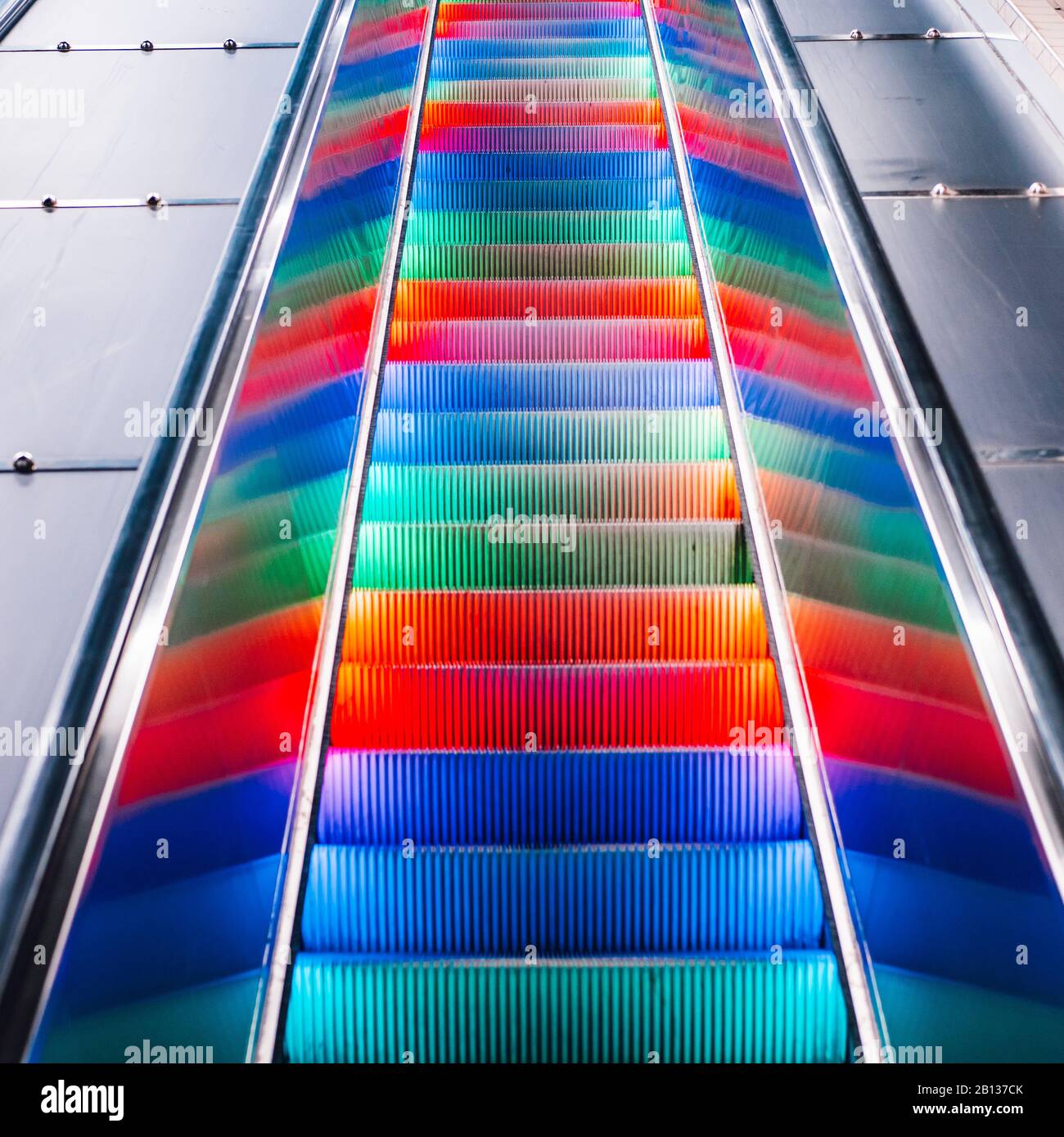 Escalator with multi-colored LED rainbow lights. Subway station in ...