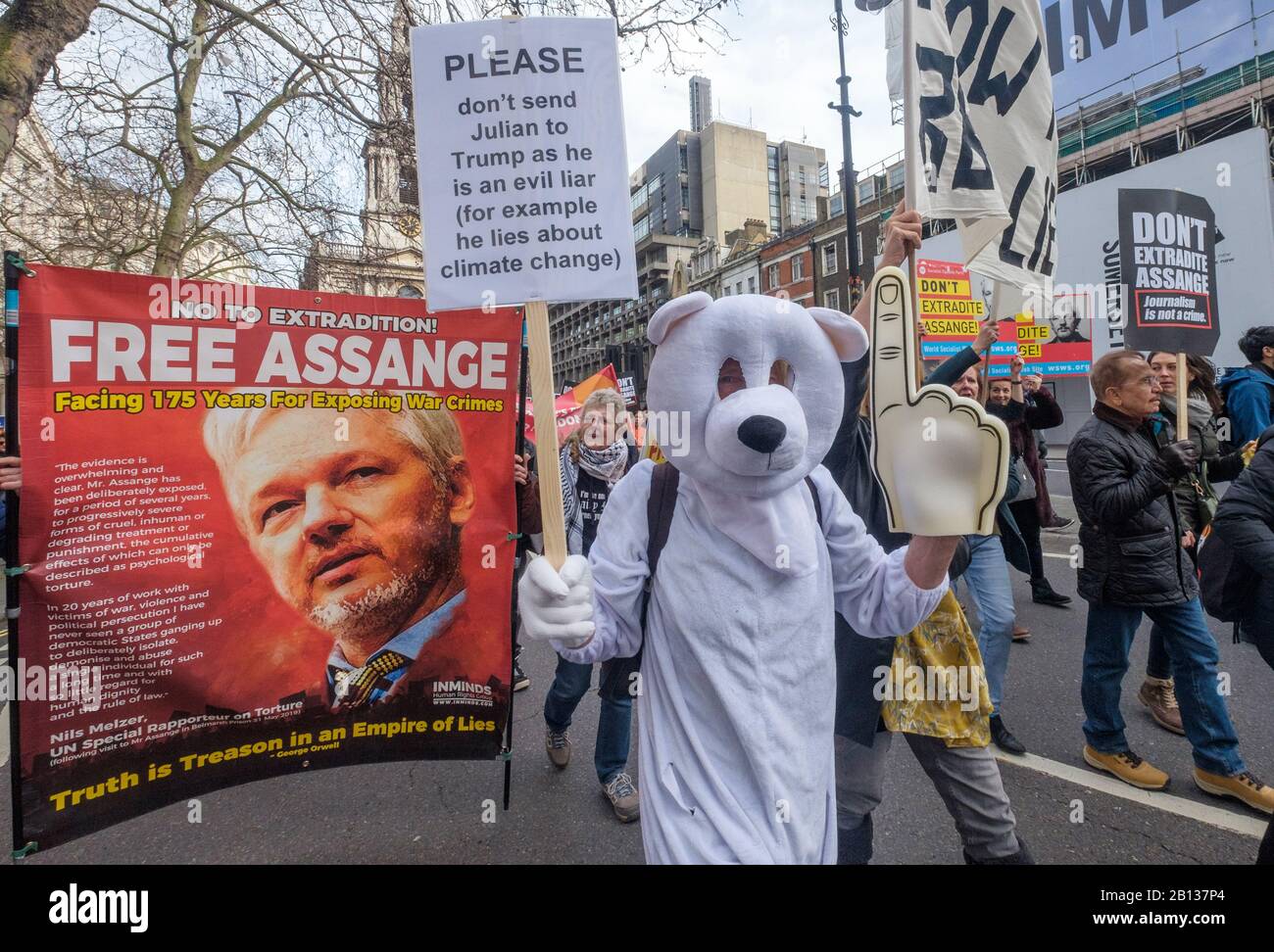 London, UK. 22nd February 2020. People, including one in a polar bear  costume march from Australia House to a rally at Parliament Square calling for  the release of Julian Assange whose extradition