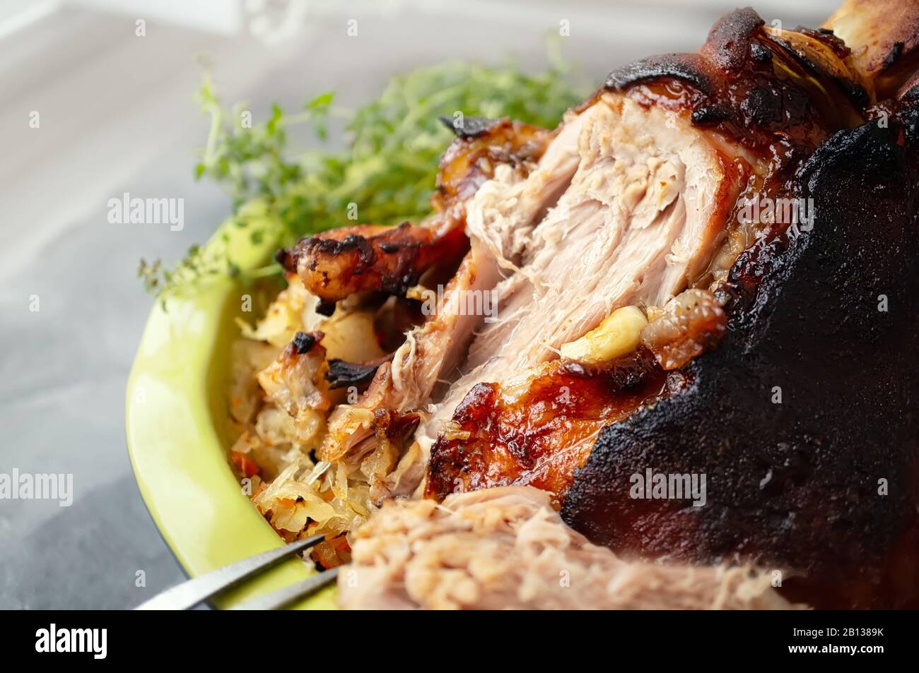 a piece of fried pork knuckle with a side dish of sauerkraut. national