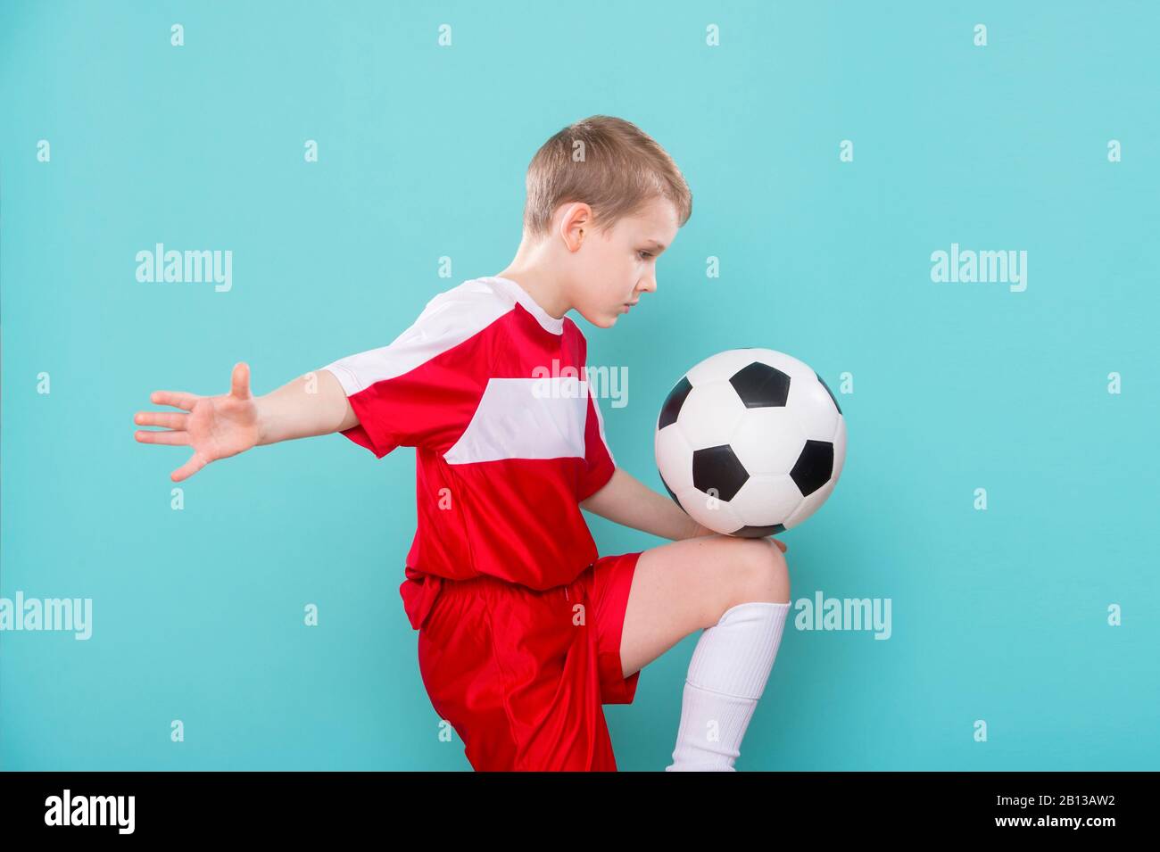 Boy With Soccer Ball On blue Background Stock Photo Alamy